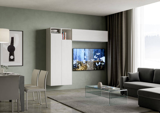 Parete attrezzata Isoka Bianca montata in soggiorno moderno con TV a parete, pensili capienti e design elegante per organizzare libri e oggetti.