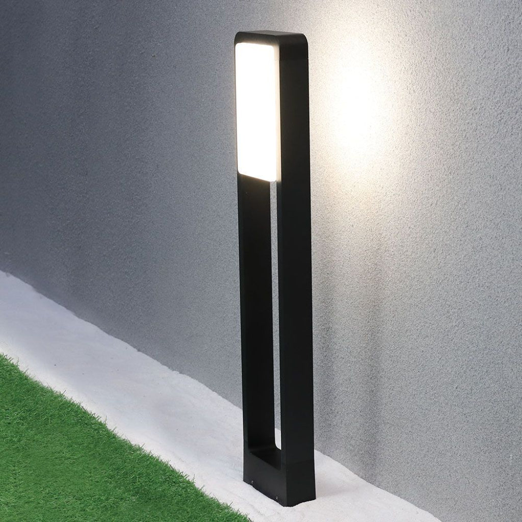 Lampada Bollard LED in metallo nero, con pannello luminoso bianco caldo, ideale per illuminazione esterna e sicurezza notturna.