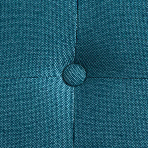 Dettaglio della tessitura in tessuto blu con bottoni decorativi, seduta imbottita e rivestimento resistente, stile moderno.