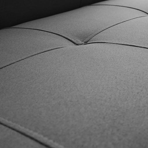 Dettaglio ravvicinato del rivestimento in tessuto grigio del divano letto MODES Carbon, con cuciture a vista e superficie morbida