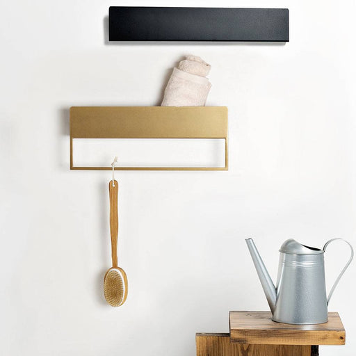 Supporto decorativo nero, oro e bianco da parete con design minimalista, perfetto per appendere asciugamani o accessori.
