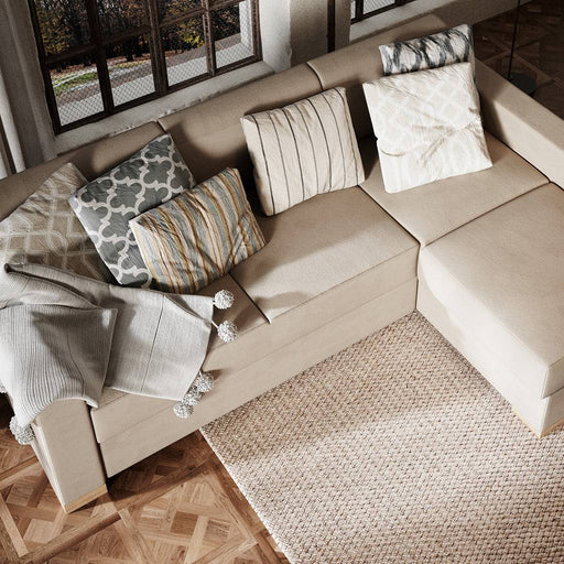 Divano angolare beige con cuscini decorativi colorati e tessuto in tessuto, perfetto per ambienti moderni e accoglienti.