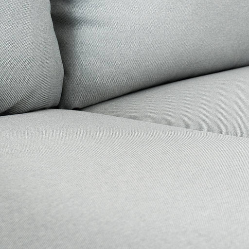 Dettaglio di tessuto in tessitura fine del divano in grigio chiaro, morbido e resistente, ideale per ambienti eleganti