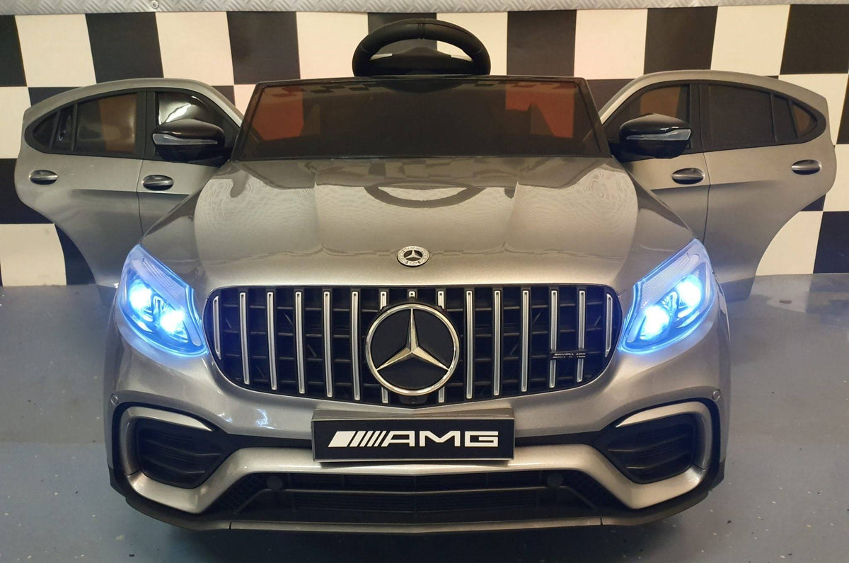 Auto elettrica per bambini Mercedes GLC 63 AMG, vista dall'alto con volante e sedili, in colore grigio metallizzato, dettagli di lusso