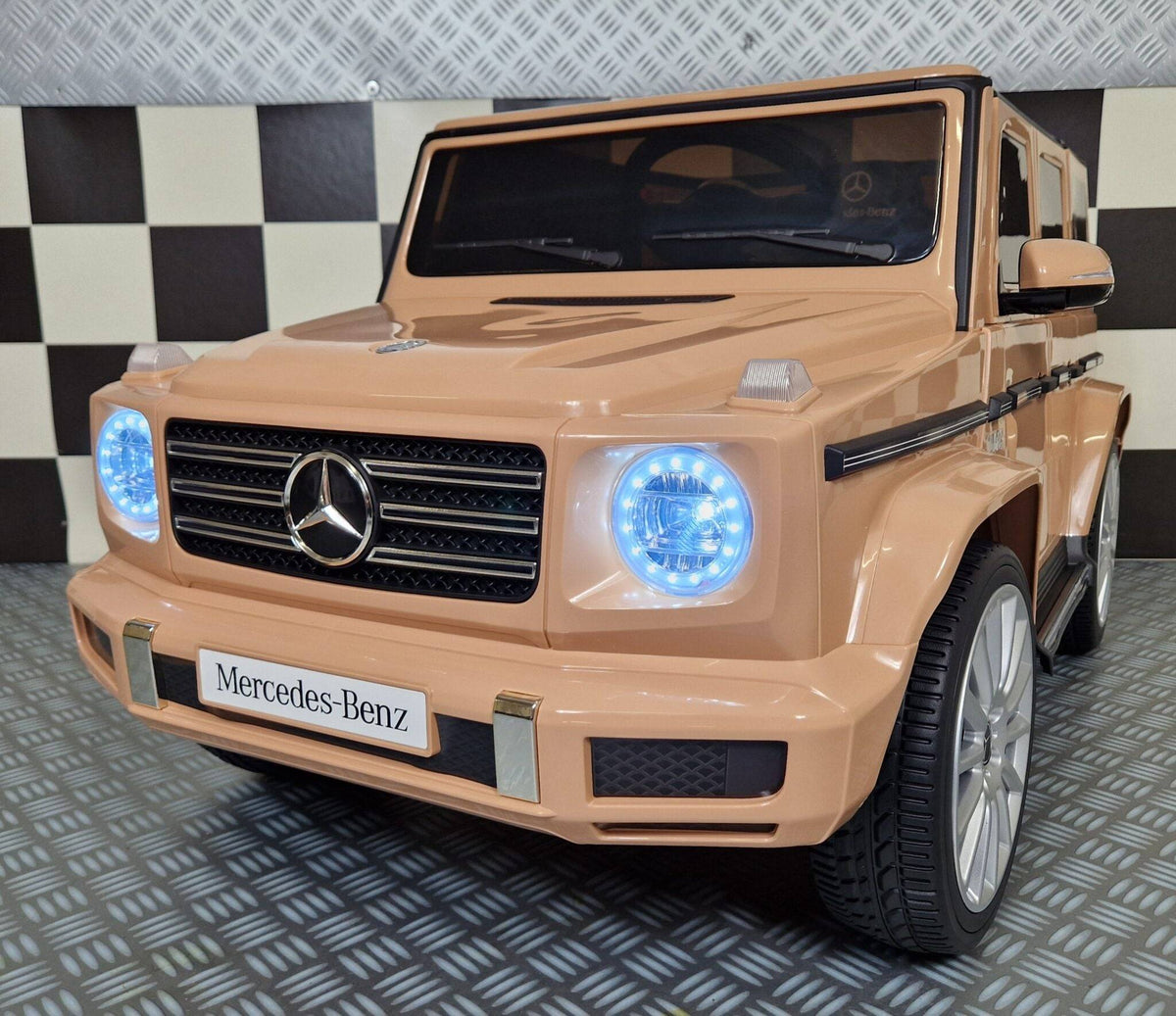 Auto elettrica per bambini Mercedes G500 colore sabbia con dettagli realistici, fari LED, portiere apribili e design di alta qualità