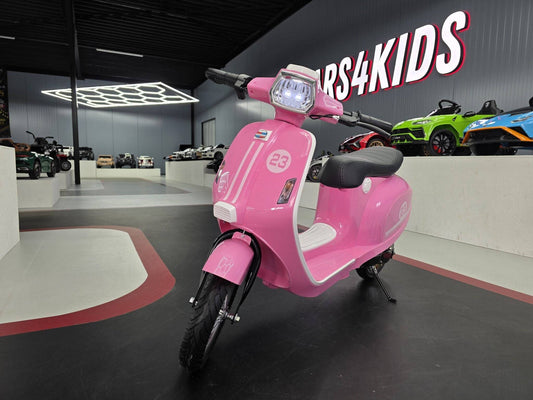 Moto elettrica per bambini rosa con luci frontali, sedile nero, manubrio e ruote nere, ideale per giochi all'aperto e divertimento