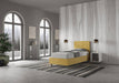 Letto singolo contenitore imbottito 90x200 microfibra Adele giallo senape in ambiente ampio. Design funzionale e accattivante per la zona notte.