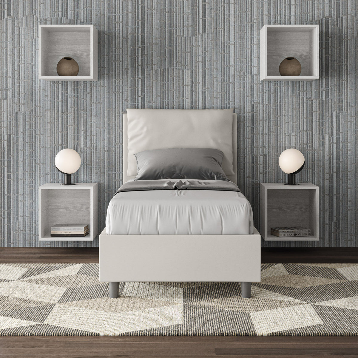 Letto singolo Antea bianco in similpelle con rete, inserito in una camera moderna con parete grigia e arredi geometrici.