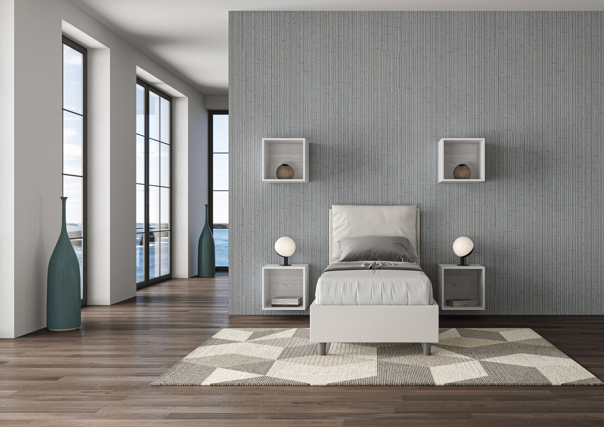 Letto singolo imbottito Antea bianco 80x190 in una stanza luminosa con vista mare, perfetto per ambienti eleganti e funzionali.