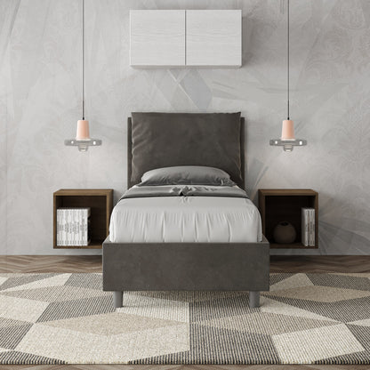 Letto Antea grigio antracite 80x190 in microfibra con testata imbottita, inserito in una camera elegante con arredi sospesi.