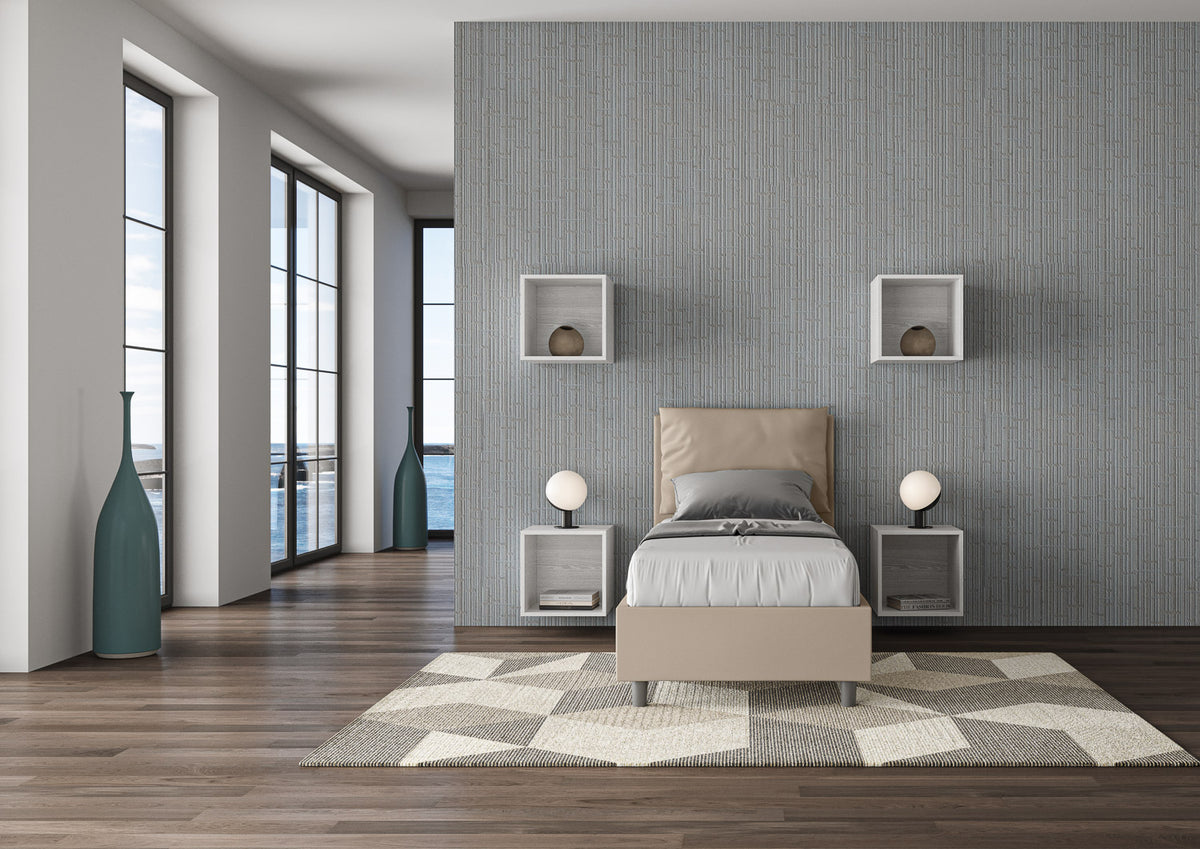 Letto singolo Antea beige 80x190 con testata imbottita, inserito in una stanza elegante con vista panoramica e arredamento geometrico.