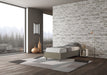 Letto singolo Azelia grigio oliva con struttura imbottita, perfetto per ambienti moderni con ampie vetrate e luce naturale.
