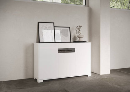 Madia bianco lucido Riflesso in soggiorno moderno, decorata con quadri e vaso. Arredo elegante per spazi luminosi e ordinati.