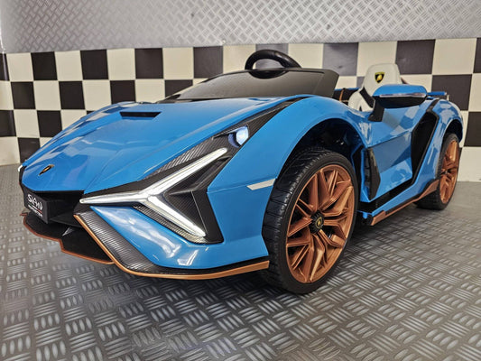 Vista frontale dell'auto elettrica per bambini Lamborghini Sian blu, con fari LED e dettagli in carbonio, stile supercar