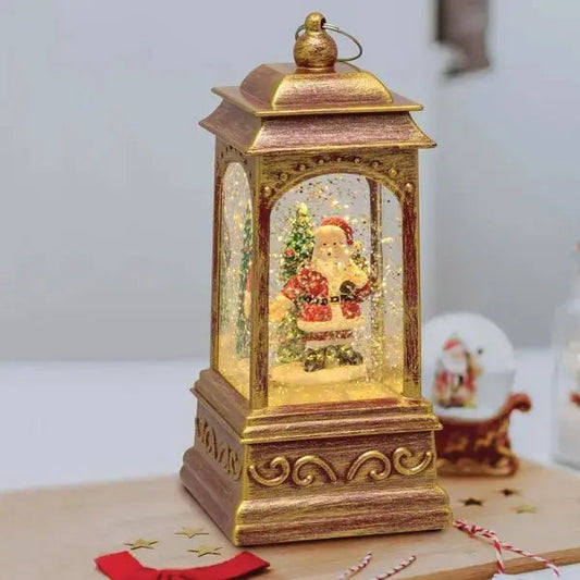 Lanterna natalizia H.20,5 cm oro con glitter e LED, con Babbo Natale e neve in movimento, decorazione luminosa Hobby Shop Solution.
