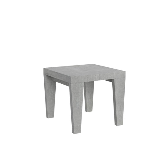 Tavolo allungabile Spimbo in finitura cemento chiaro, ideale per ambienti moderni e funzionali. Design compatto e geometrico per spazi ridotti.