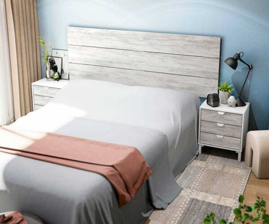 Testiera letto con grande pannello in legno bianco chiaro, abbinata a comodini bianchi con cassetti, in una camera moderna e luminosa.