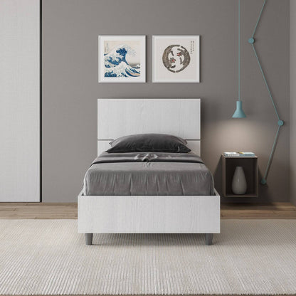 Letto singolo 80x200 Demas bianco in una camera moderna, con testata dritta e giroletto in nobilitato, ideale per arredamenti eleganti.