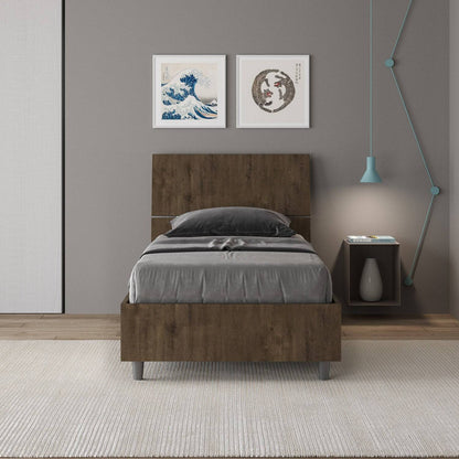 Letto singolo 80x200 Demas effetto legno scuro in una camera moderna, con testata dritta e giroletto in nobilitato, perfetto per arredamenti eleganti.