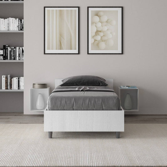 Letto singolo Nuamo bianco in una camera moderna con libreria integrata, perfetto per un arredamento minimalista.