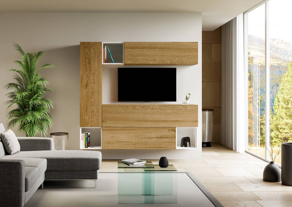 Parete attrezzata Isoka A26 con moduli in legno e bianco, montata in soggiorno moderno con TV, perfetta per libri e oggetti decorativi.