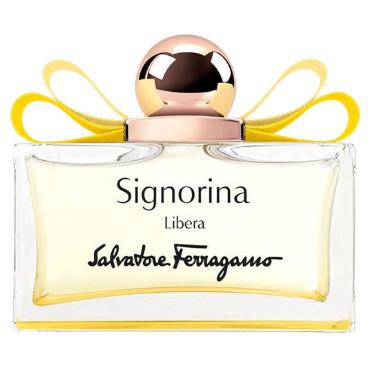 Profumo Signorina Libera di Salvatore Ferragamo in bottiglia di vetro trasparente con cappuccio rosa e fiocco giallo, confezione elegante